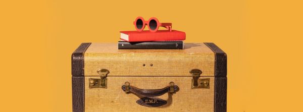 vintage suitcase with books and sunglasses
